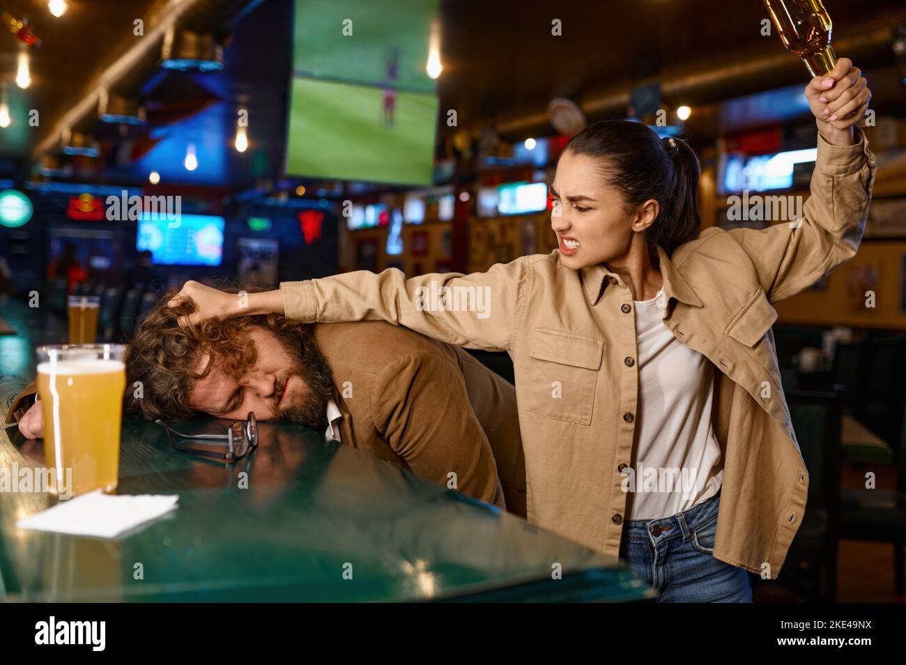 Unhappy and angry fans fighting at sport bar Stock Photo