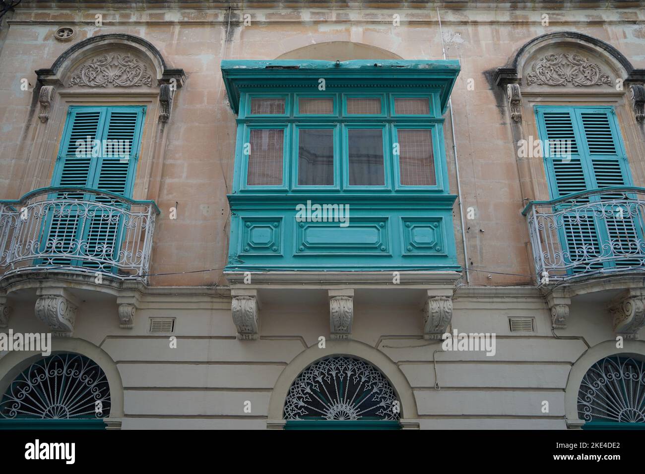 painted bow windows Malta Rabat medieval village building street Stock