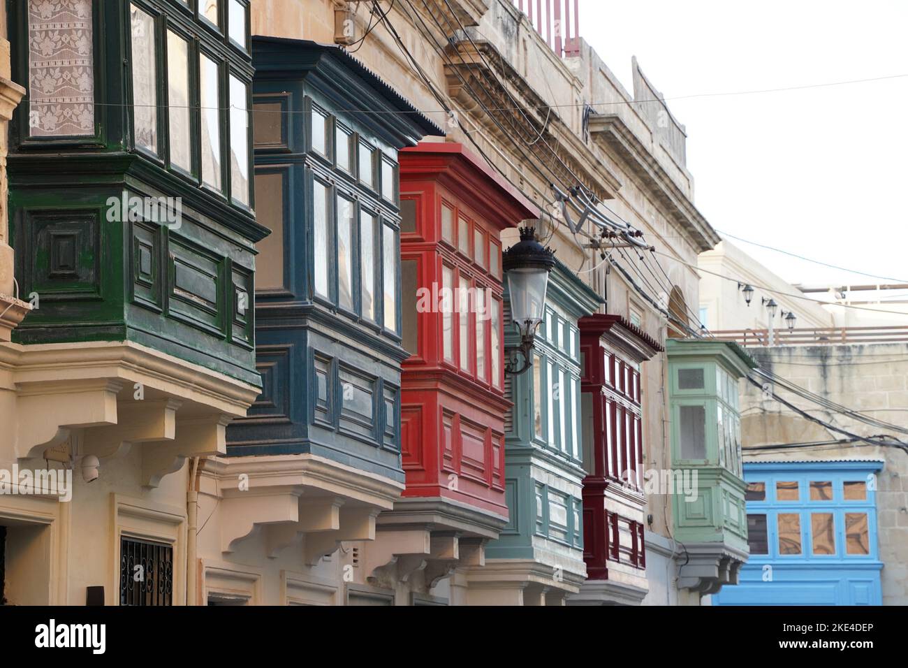 painted bow windows Malta Rabat medieval village building street Stock