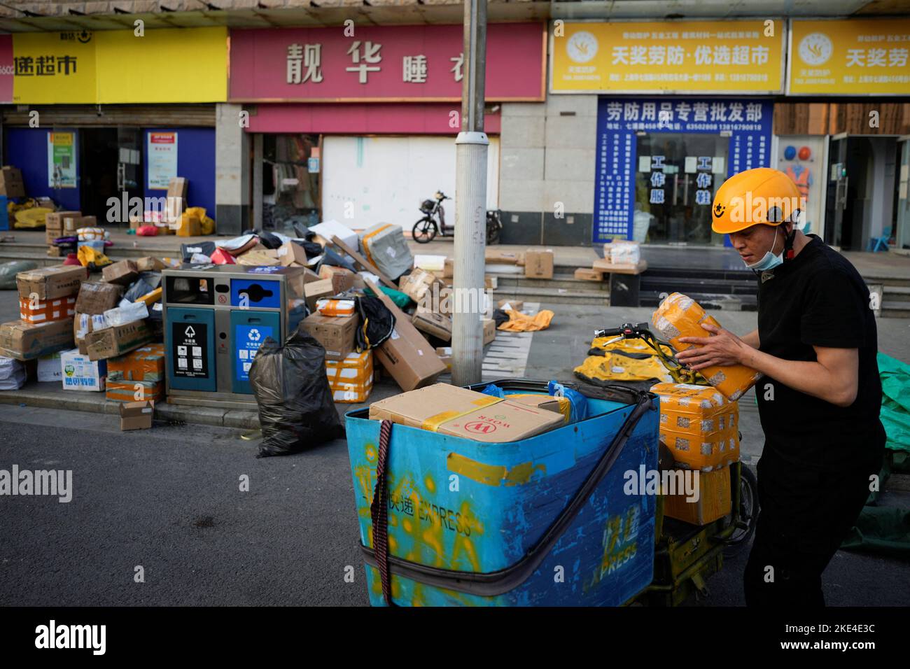 A delivery worker sorts parcels at a makeshift logistics station ahead of Alibaba's Singles' Day shopping festival, following the coronavirus disease (COVID-19) outbreak in Shanghai, China, November 10, 2022. REUTERS/Aly Song Stock Photo