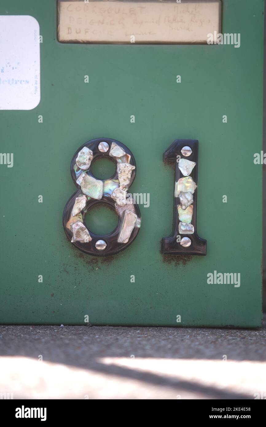 A closeup shot of a green post box number 81 Stock Photo