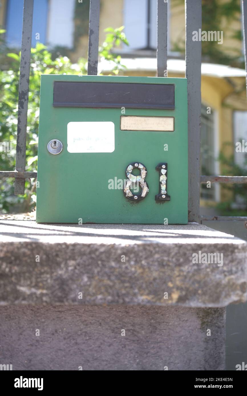 A closeup shot of a green post box number 81 Stock Photo