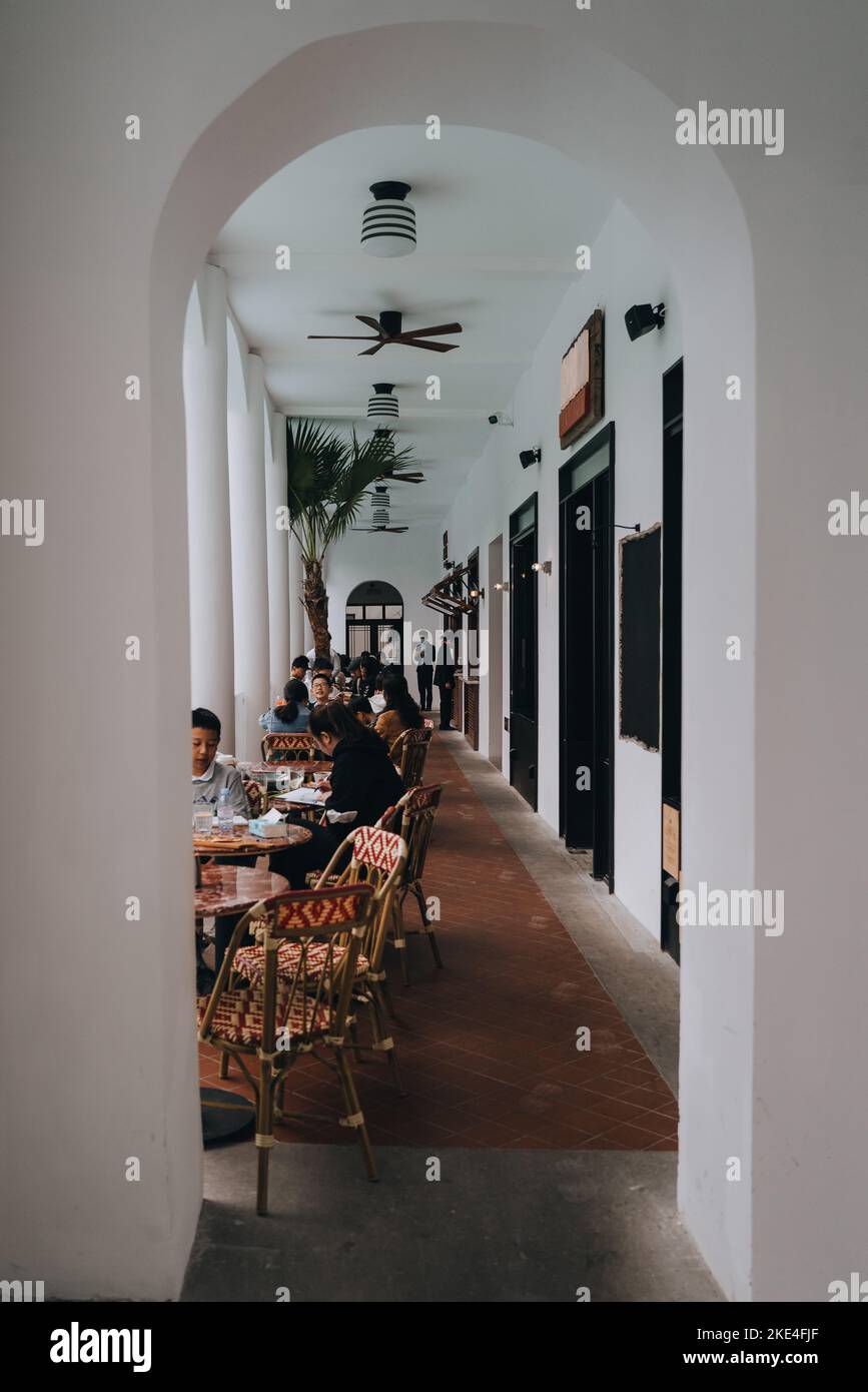 A vertical shot of people dining at the famous Colombia Circle in Shanghai Stock Photo