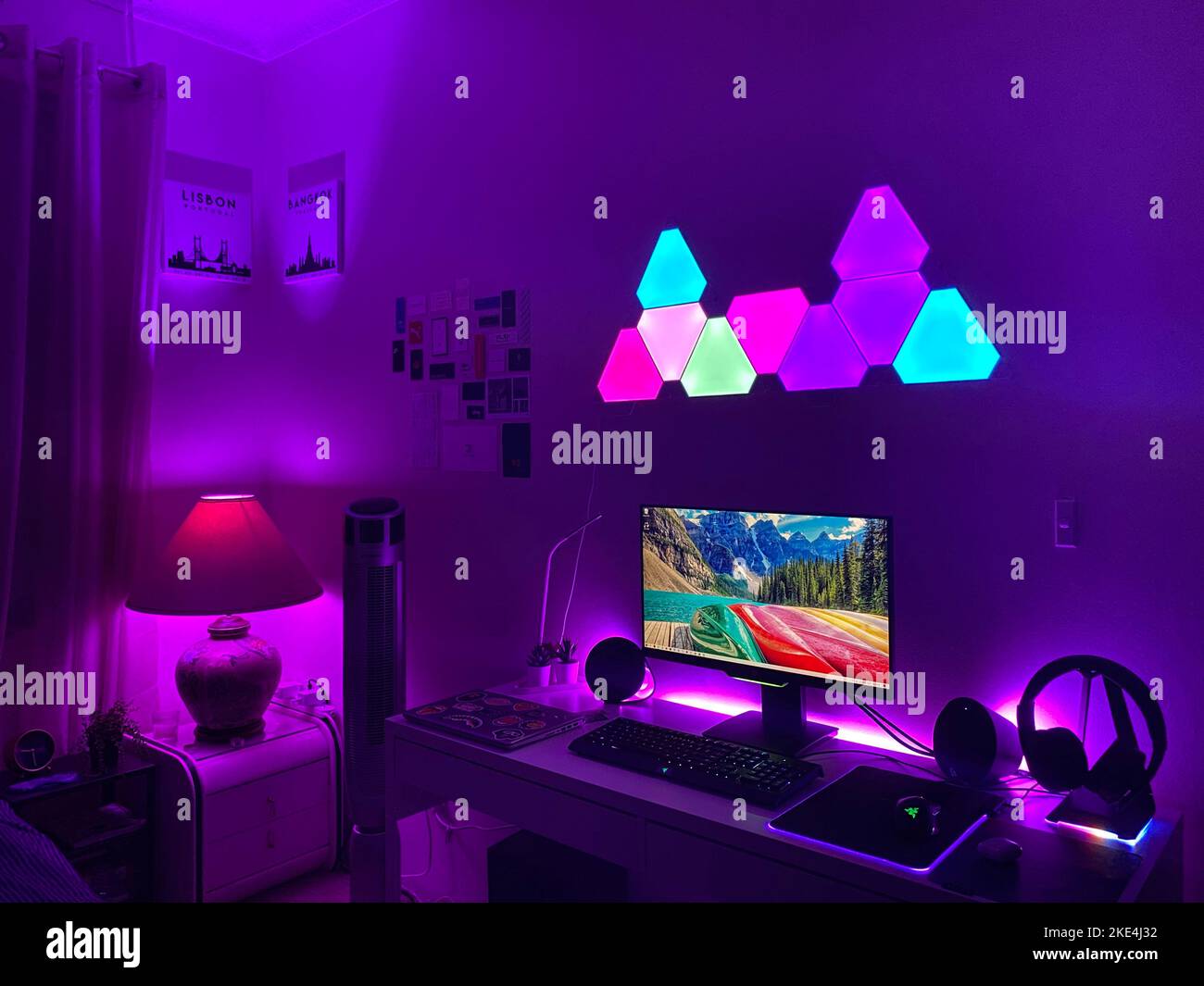 A DIY gaming set up with a PC and headphones in a glowing illuminated ...