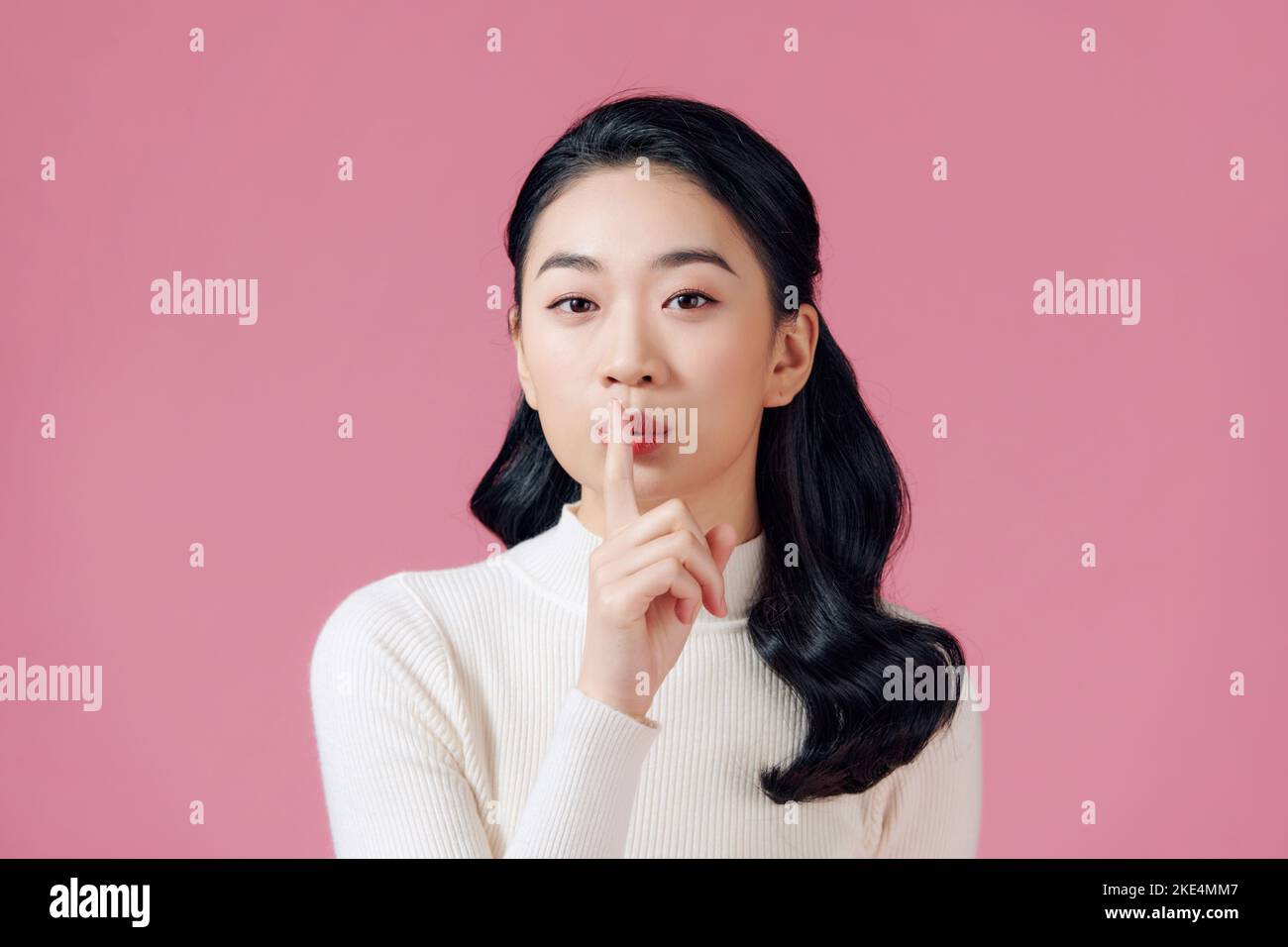 Sassy and creative cute asian girl prepare special surprise for girlfriend shushing with a finger over lip, smiling mysterious or sly Stock Photo