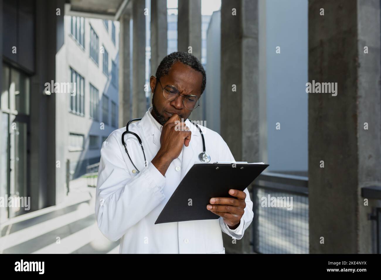 Serious and thinking mature african american doctor outside modern ...