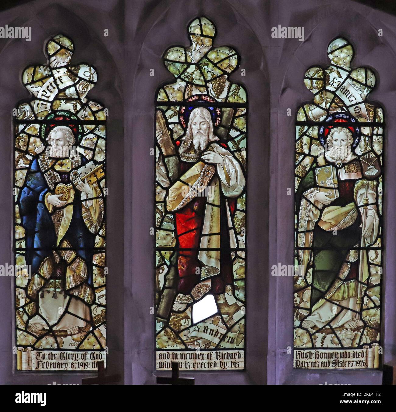 Stained glass window by Percy Bacon & Brothers depicting Saints Peter, Andrew and James the Great, St Barnabas Church, Emmer Green, Reading, Berkshire Stock Photo