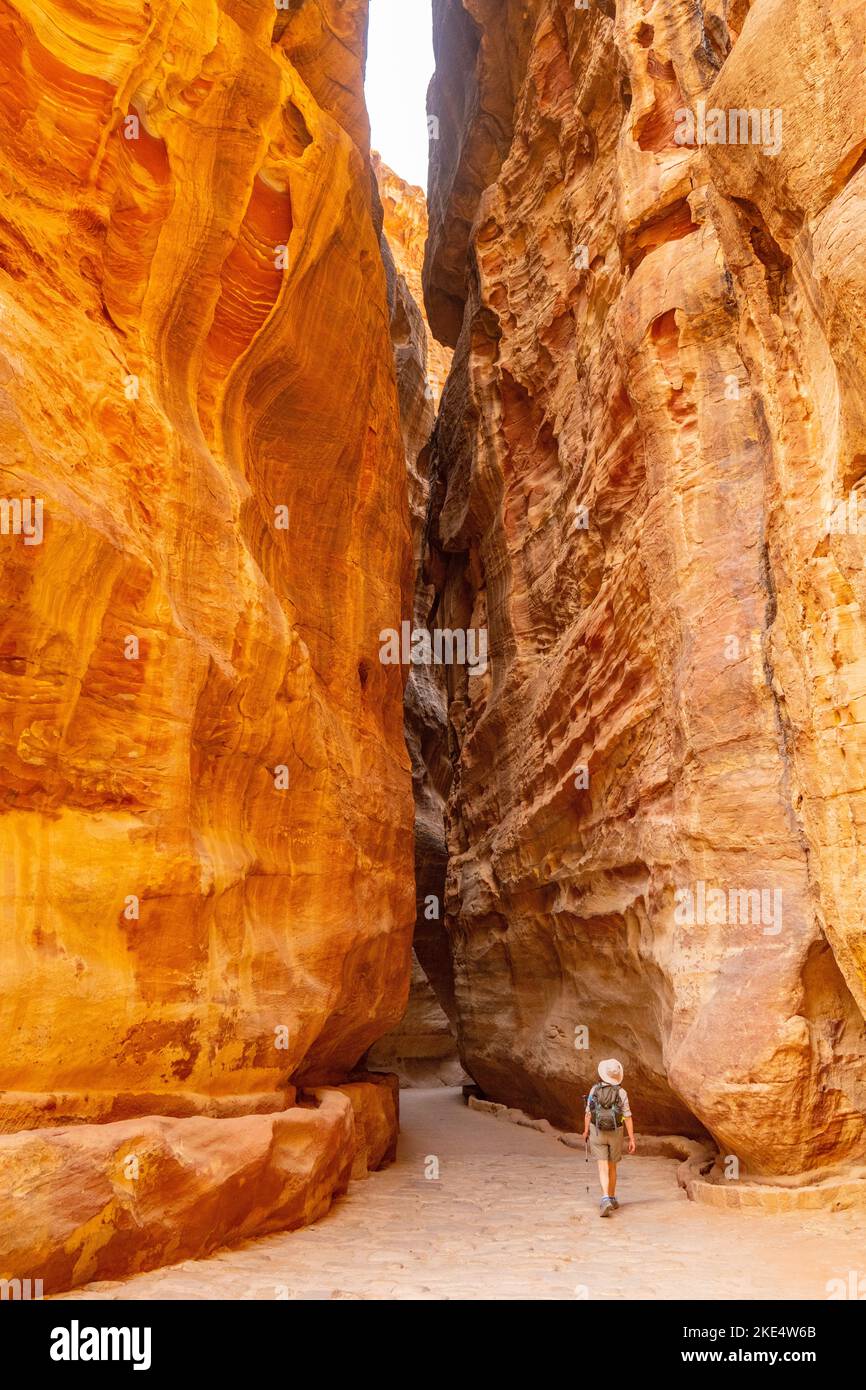A Siq, the path through the rocks which is the entrance to Petra Jordan with Nabatean aqua duct cut into rock on left Stock Photo