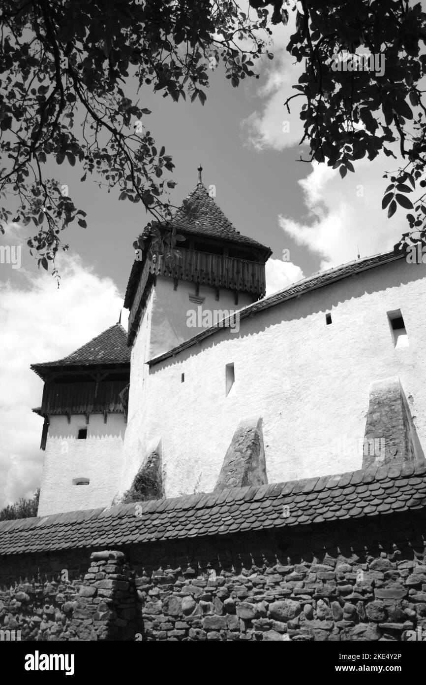 Black and white image of Viscri fortified Lutheran Church, UNESCO World Heritage Site, Viscri, Brasov County, Transylvania, Romania Stock Photo