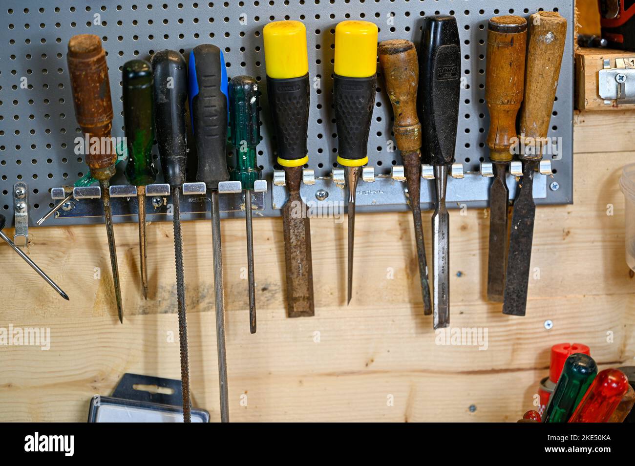 tools hanging on wall in workshop at home Stock Photo