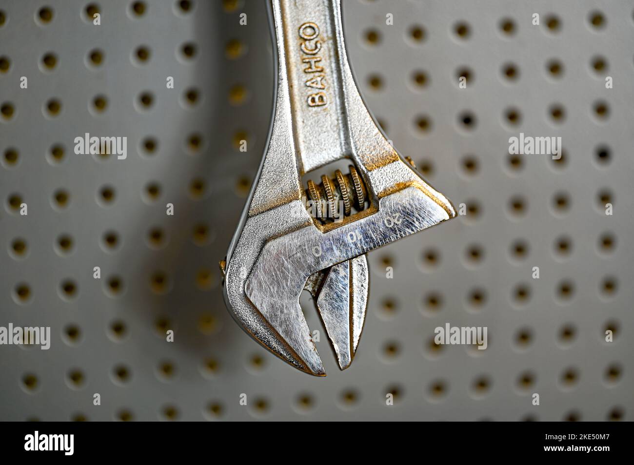 silver colored spanner hanging on tool board Stock Photo