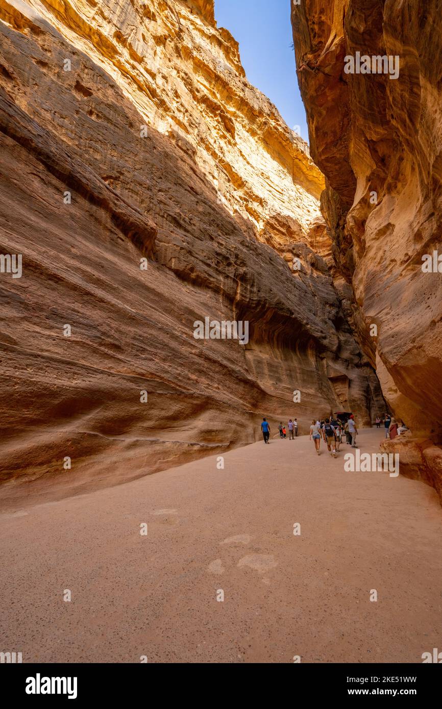 A Siq, the path through the rocks which is the entrance to Petra Jordan with Nabatean aqua duct cut into rock on right Stock Photo