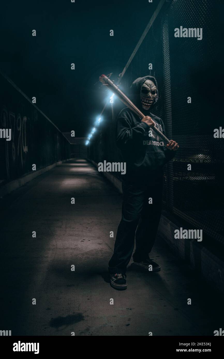 Alone in the dark holding a spiked bat Stock Photo Alamy