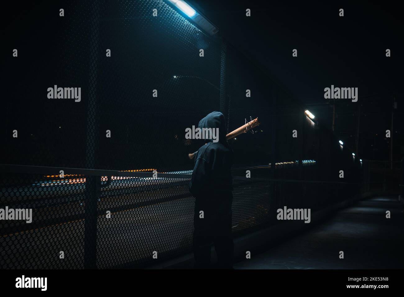Character standing alone in the dark with a spiked bat Stock Photo Alamy