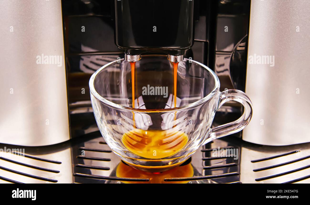 Closeup of modern fully automatic coffee maker machine outlet, one