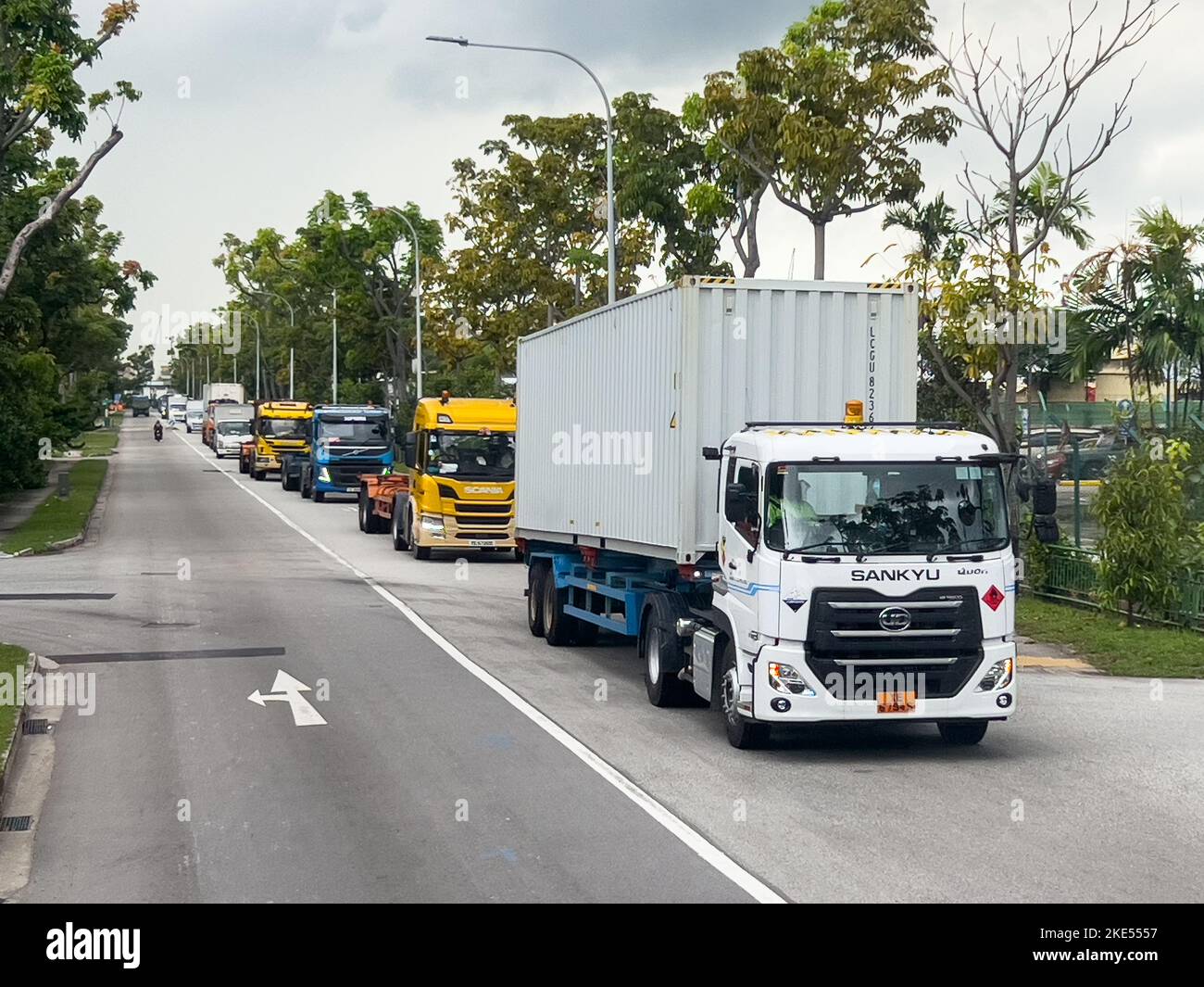 Heavy industrial vehicle transportation line up on the road to respective destination. Singapore Stock Photo