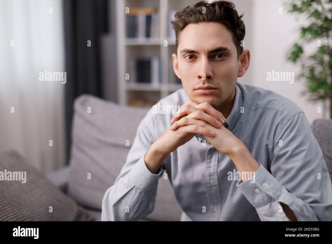 Confident man on couch Stock Photo