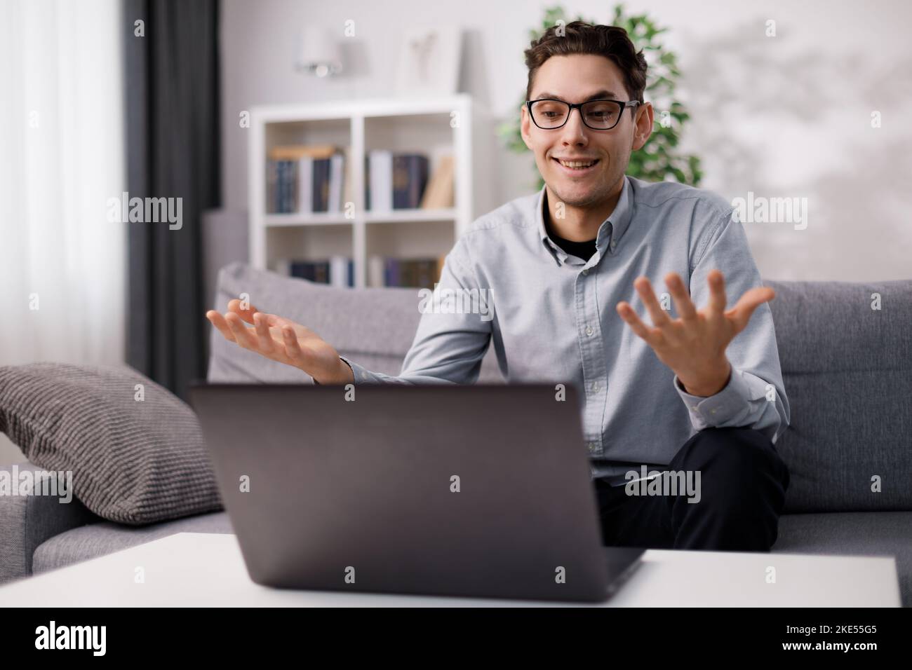Man using laptop on couch Stock Photo
