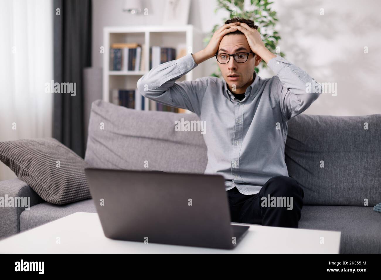 Shocked man looking on laptop Stock Photo