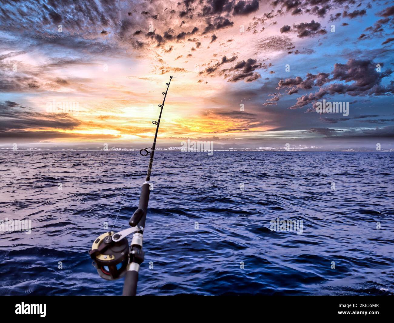 https://c8.alamy.com/comp/2KE55MR/fishing-rod-and-reel-anchored-to-the-ship-looking-for-a-big-catching-in-a-deep-seascape-offshore-at-sunrise-2KE55MR.jpg