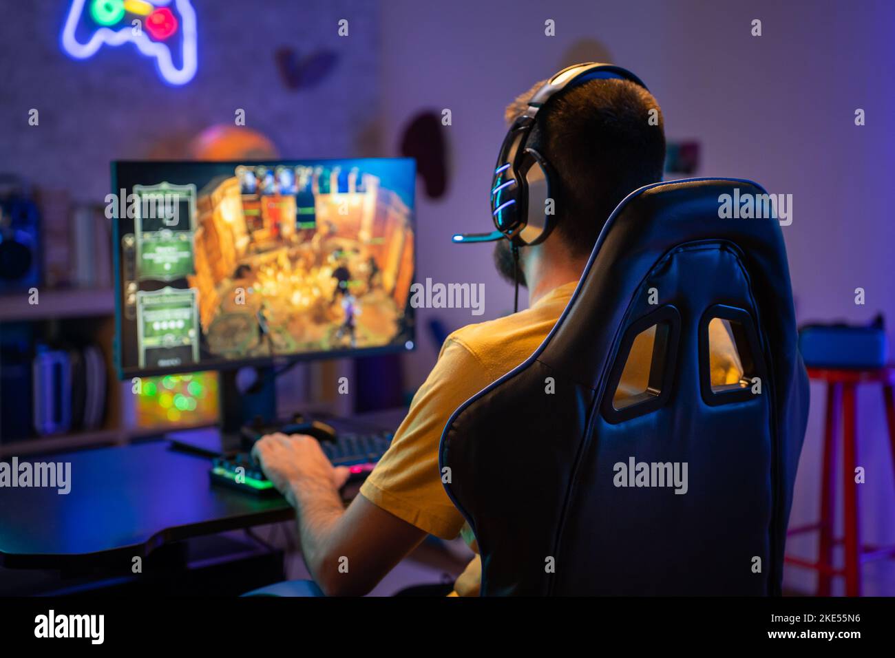 Professional Gamer Playing Online Video Game on Computer with Colorful Neon Led Lights. Stock Photo