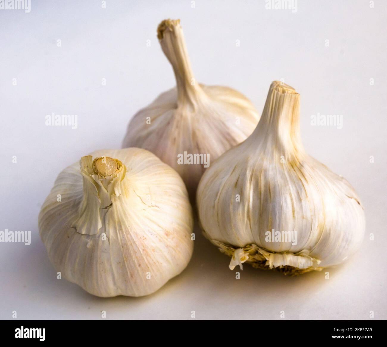 garlic heads and cloves on white background Stock Photo - Alamy