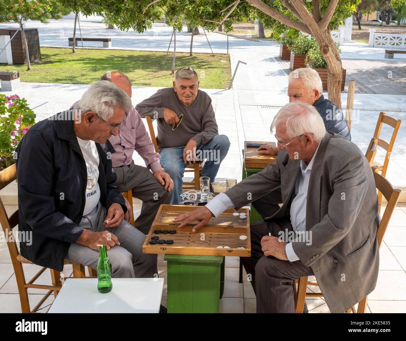 A group of senior men playing backgammon board game, Pafos town centre, Cyprus. Stock Photo