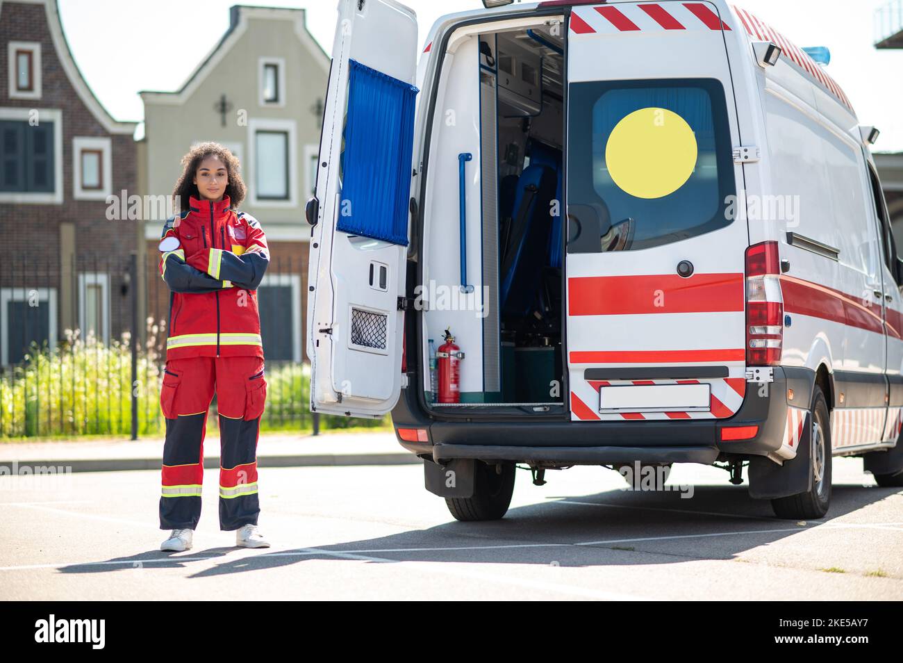 Tranquil female paramedic beside the ambulance van Stock Photo