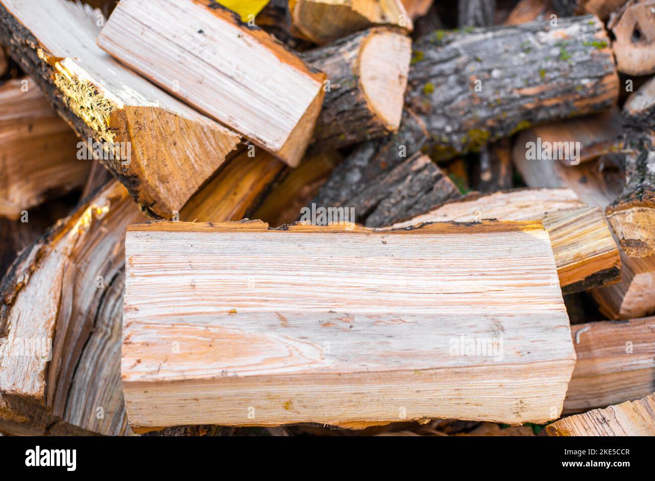 A pile of firewood chopped close-up for heating a house in the countryside. Stock Photo