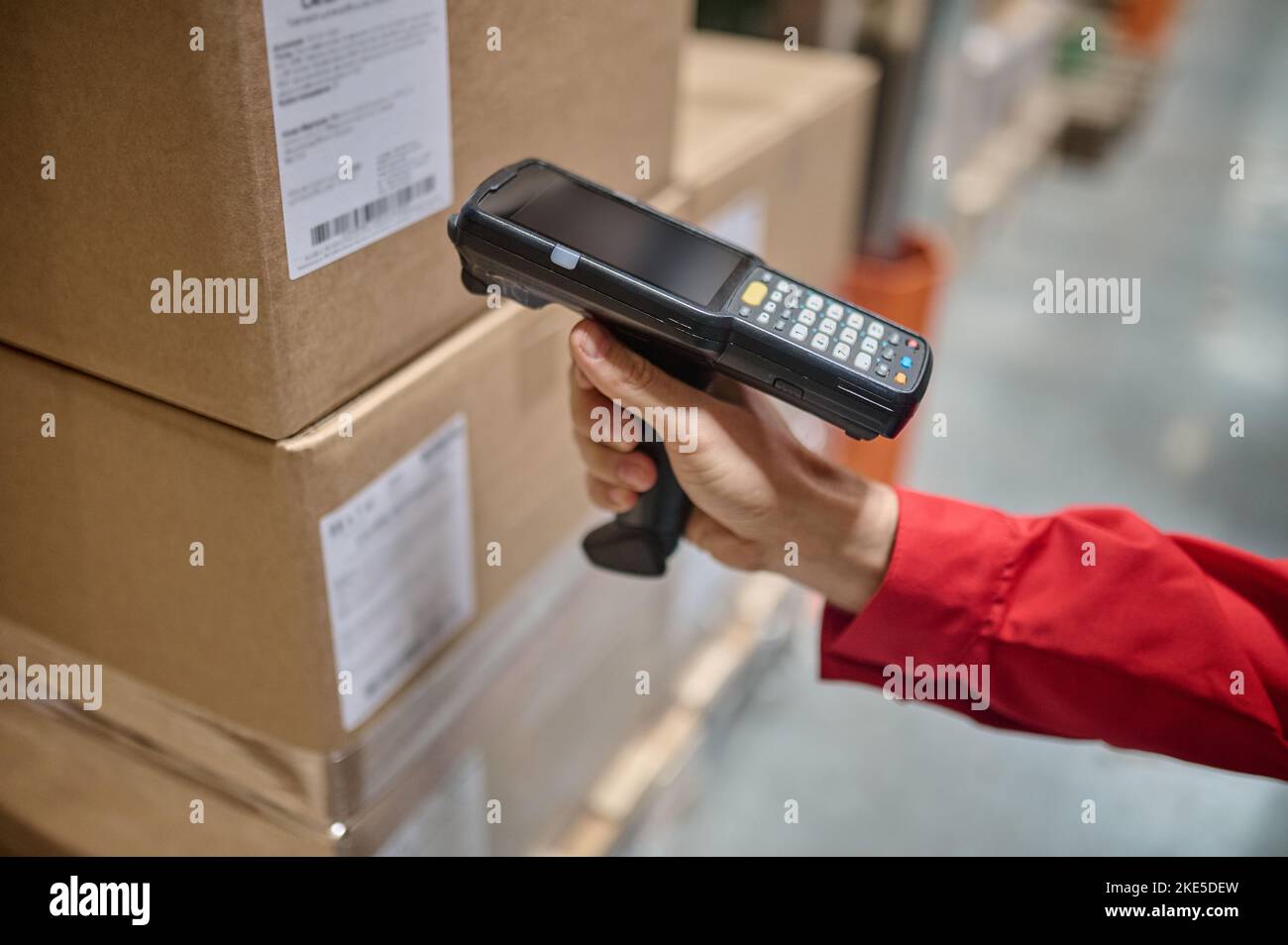 Warehouse employee scanning packaging information using a scanner Stock Photo