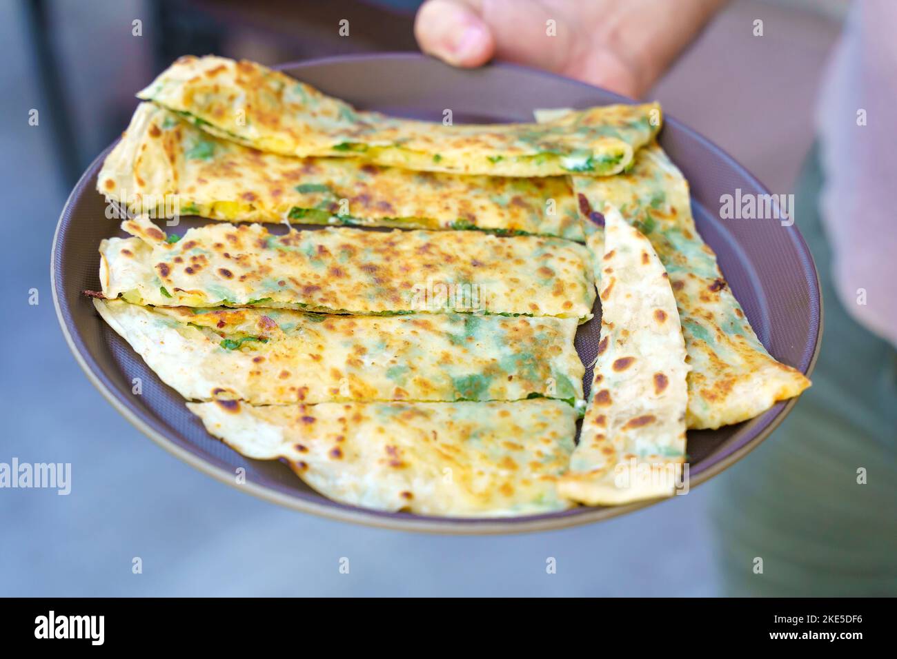 Traditional Turkish food cuisine. Gozleme bread on a plate. Dish stuffed with cheese and herbs. High quality photo. High quality photo Stock Photo