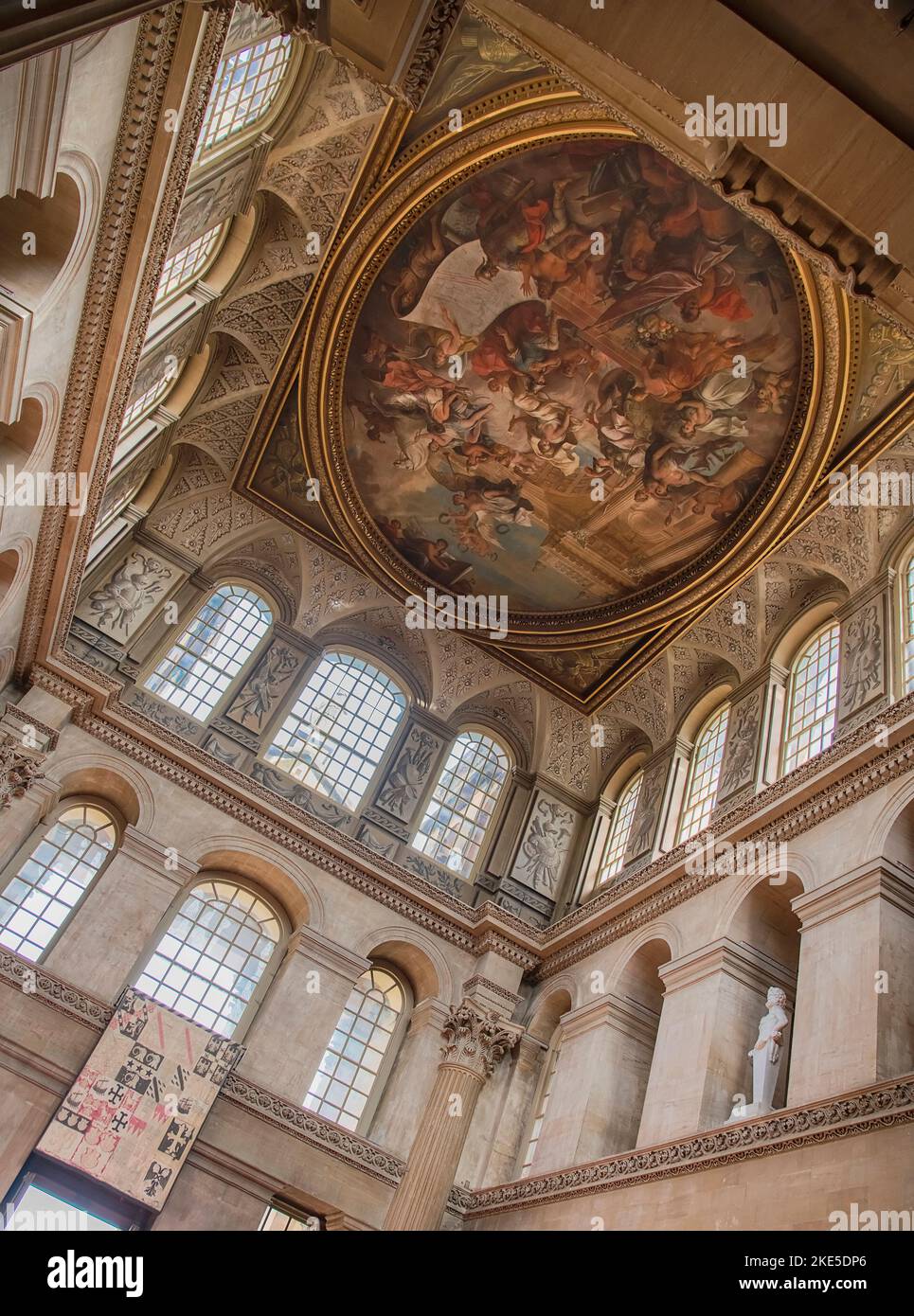 England, Oxfordshire, Woodstock, Blenheim Palace, The Great Hall featuring a painting from 1716 by Sir James Thornhill depicting the Duke of Marlborough kneeling to Britannia, proffering a plan of the Battle of Blenheim. Stock Photo