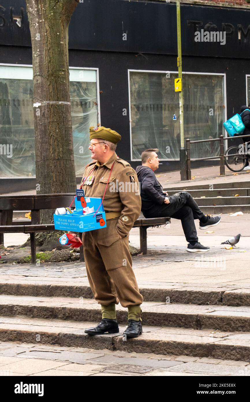 Man dressed in vintage army uniform selling poppies in Norwich city