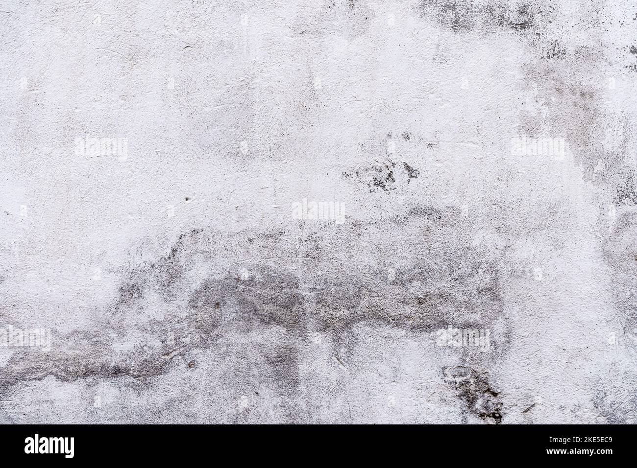 Old concrete stone wall covered with cracked plaster and dirty grunge textured surface. High quality photo Stock Photo