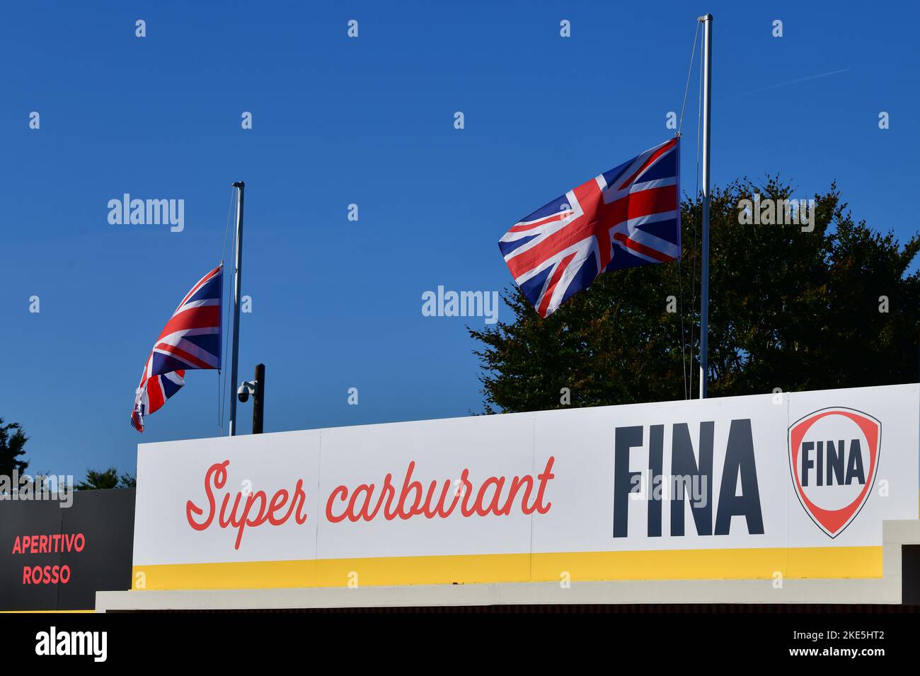 Super carburant FINA, Pit lane signage, flags at half mast, Goodwood