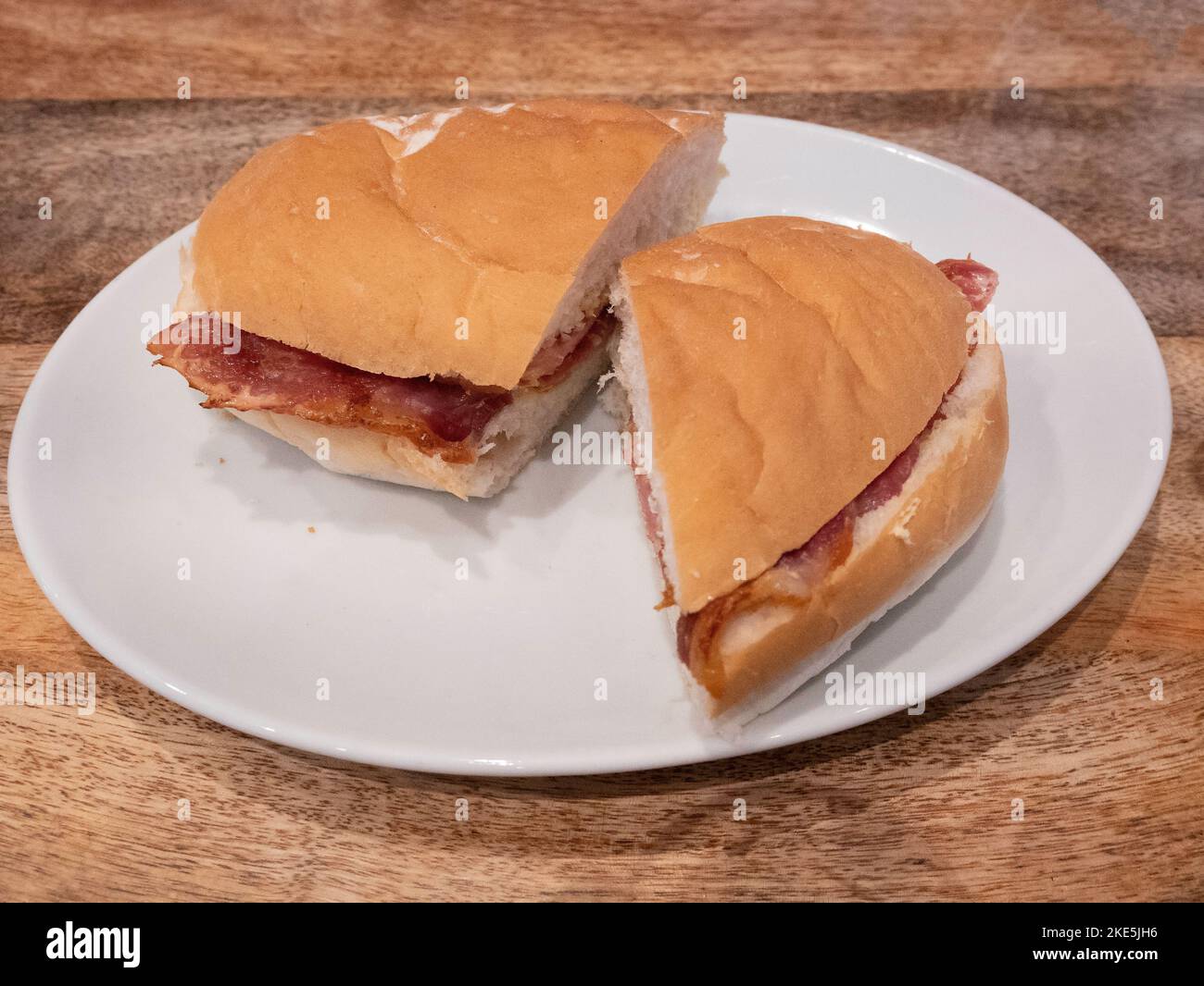 Lunchtime snack in a Yorkshiew café, grilled Bacon in a soft white Roll Stock Photo