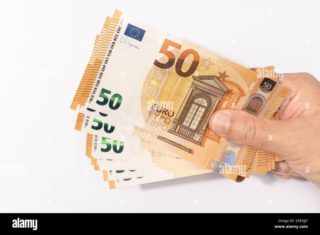 Hand holding many 50 euro banknotes on white background Stock Photo - Alamy