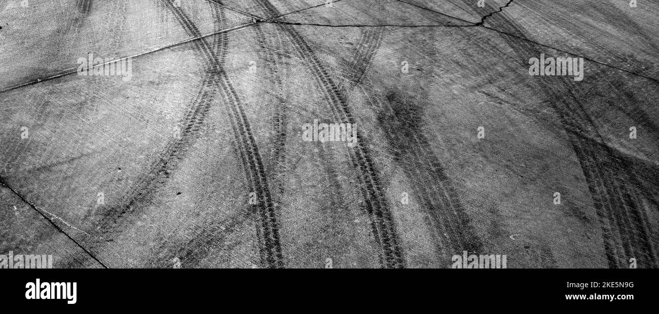 Black tire tracks or marks from driving on cement drive Stock Photo Alamy