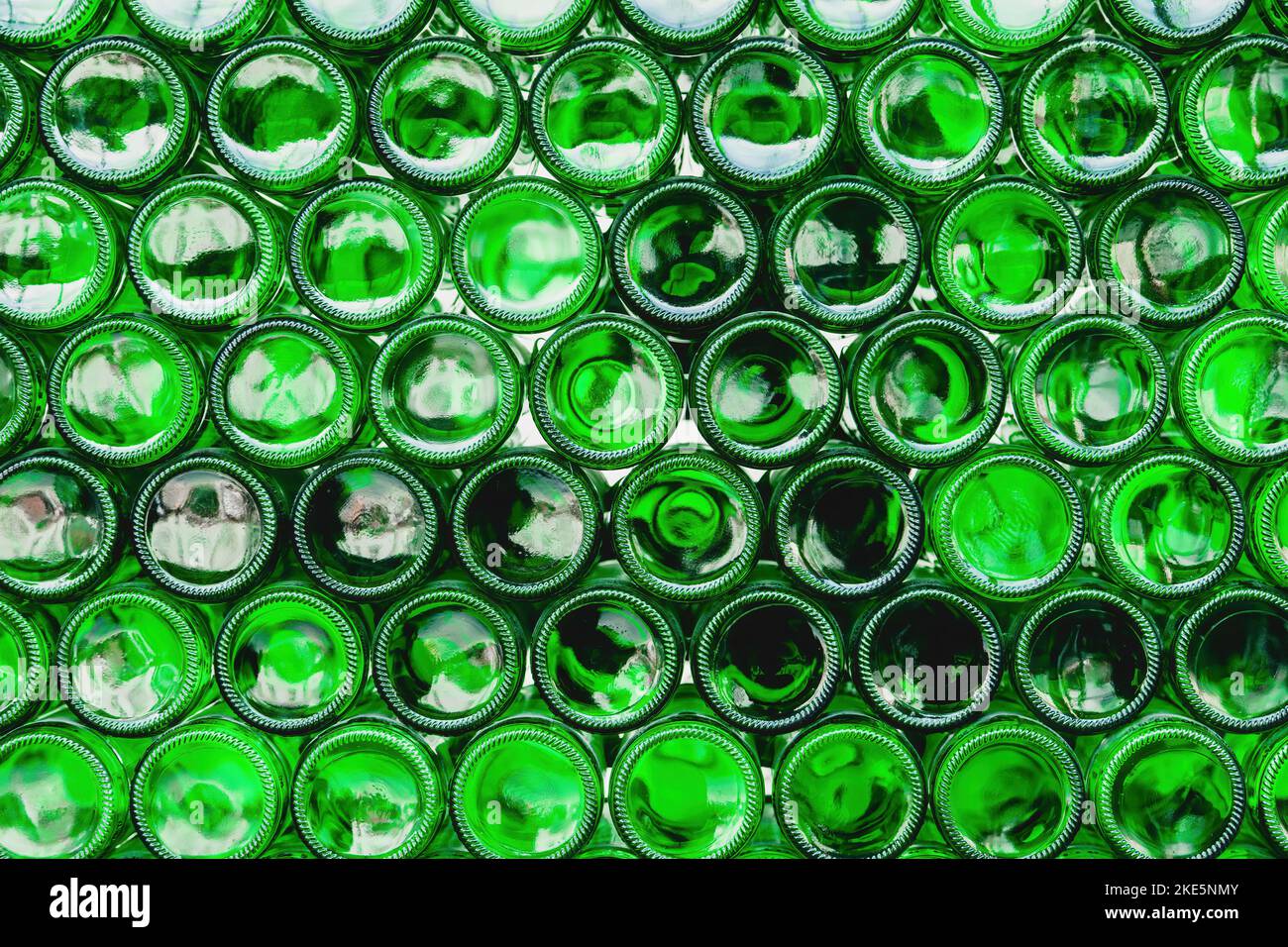 Glass bottles green. Green glass bottles of beer. Wall formed by green