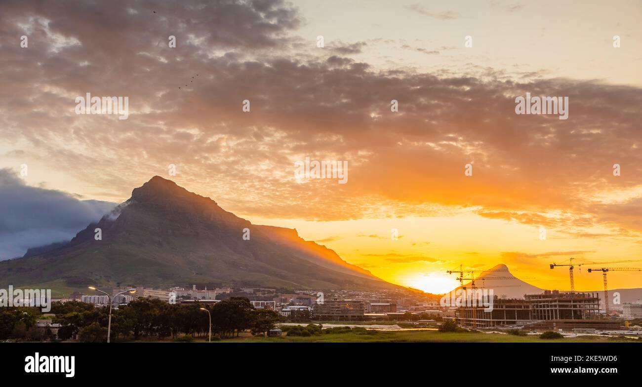 Construction cranes on building site at sunset in Cape Town, South Africa Stock Photo