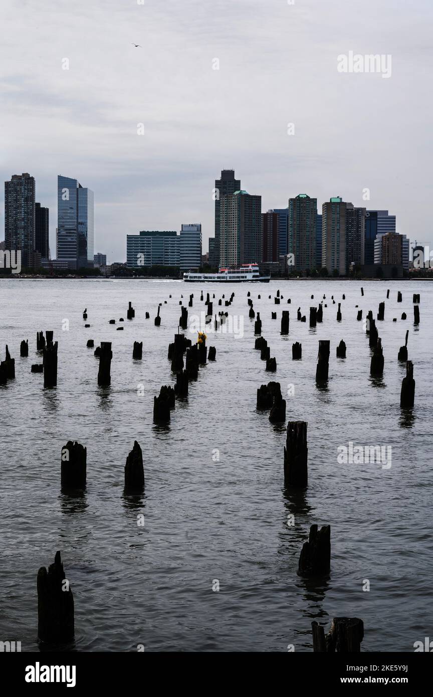 Pillars point at white ferry sailing by the Jersey City skyline Stock Photo