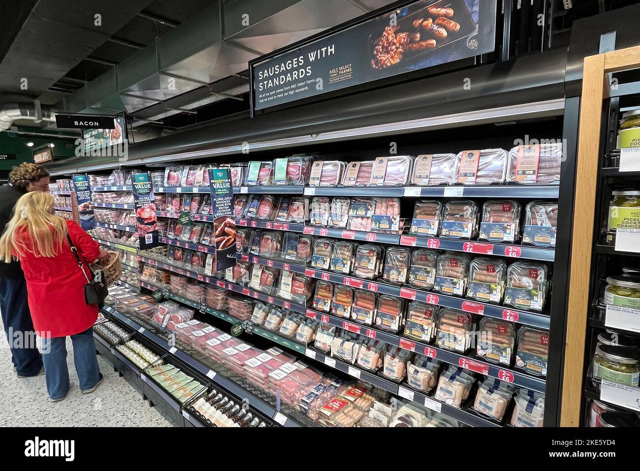 Customers look at packaged meat products at M and S food hall at