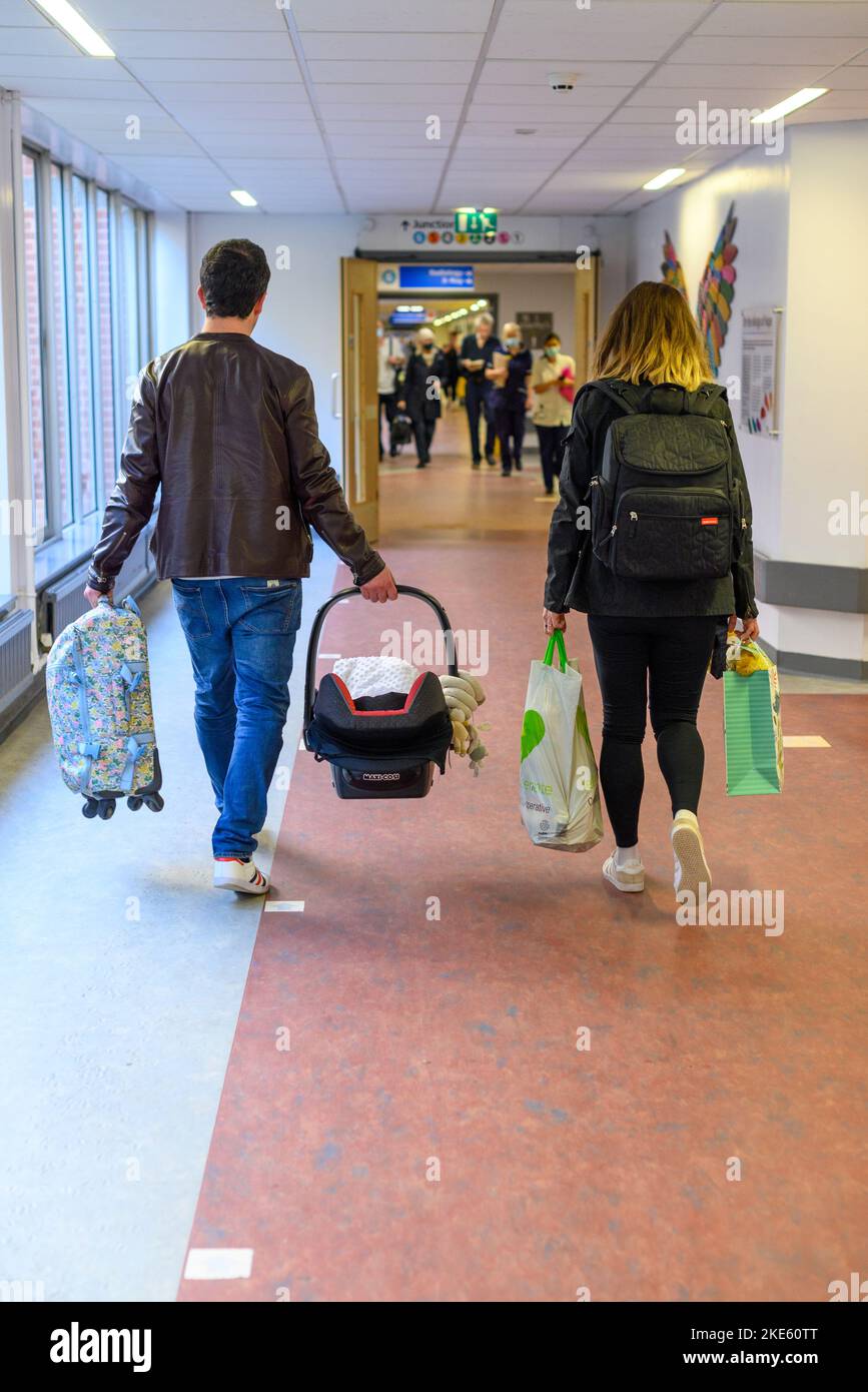Young couple leaving hospital with a new baby Stock Photo Alamy