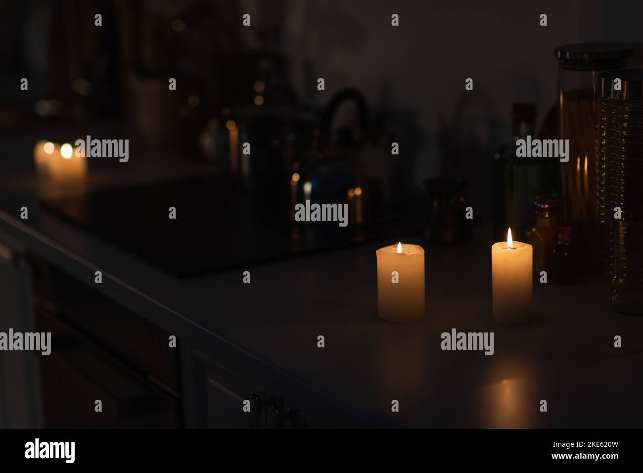 Candle light on a table, shining in the dark. Power outage, blackout  concept background Stock Photo - Alamy