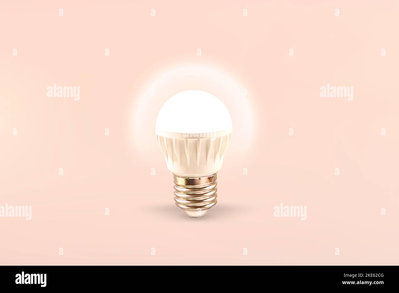Luminous LED lamp on a light background. Energy saving technology. Stock Photo