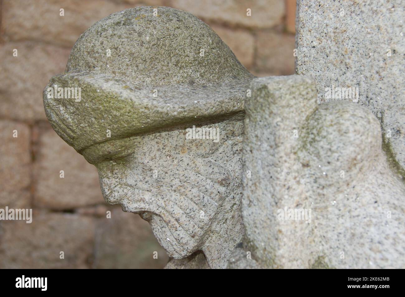 Very old pilgrim figure head sculpted on a column of a building in Tui in Portugal on the pilgrimage route known as the Way of St. James. Stock Photo