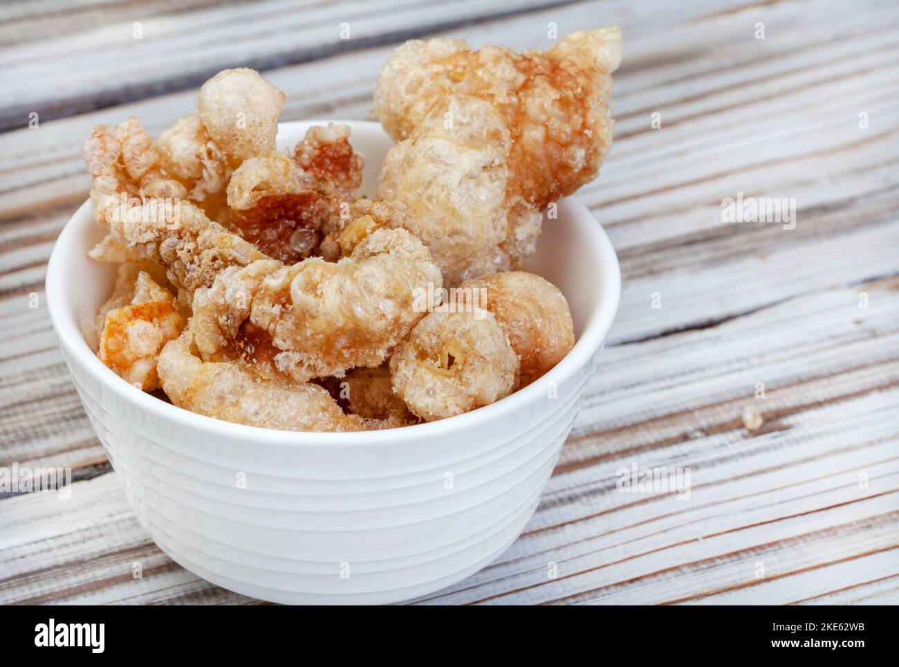 Perfectly crisp, pork rind or crackling in white bowl with copy space Stock Photo Alamy