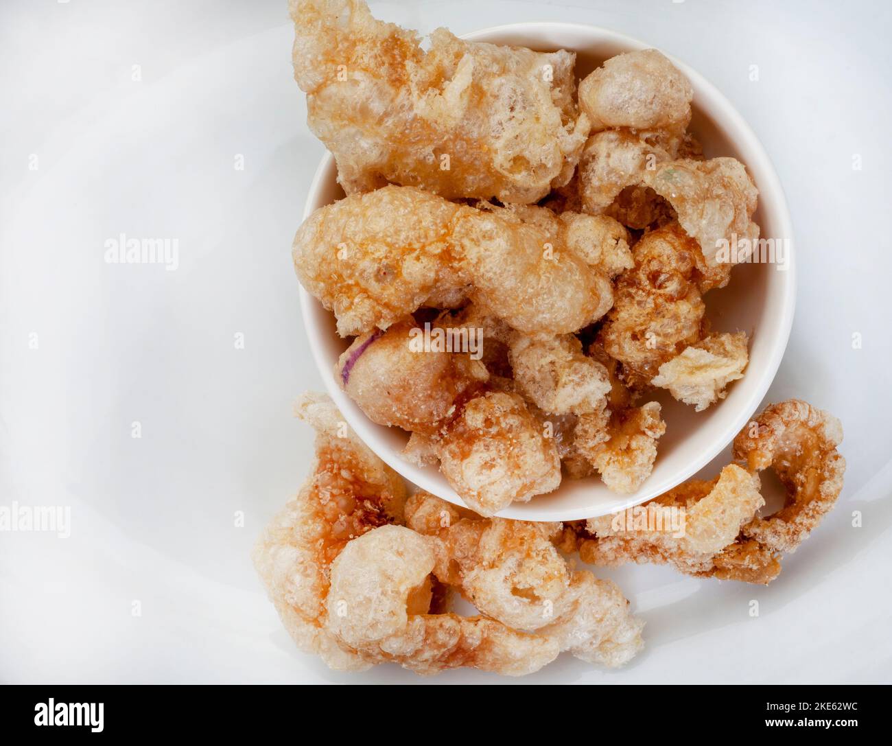 Cooking Pork Rind Perfectly crisp, pork rind or crackling in white bowl with copy space ...
