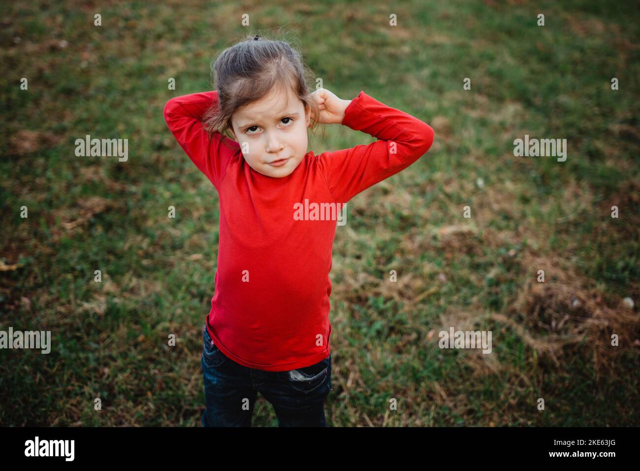 Cute little girl standing in the nature during autumn day Stock Photo