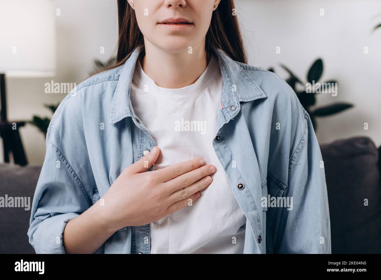 Cropped shot unhealthy sad caucasian woman having or symptomatic reflux acids, Gastroesophageal reflux disease, Because the esophageal sphincter separ Stock Photo